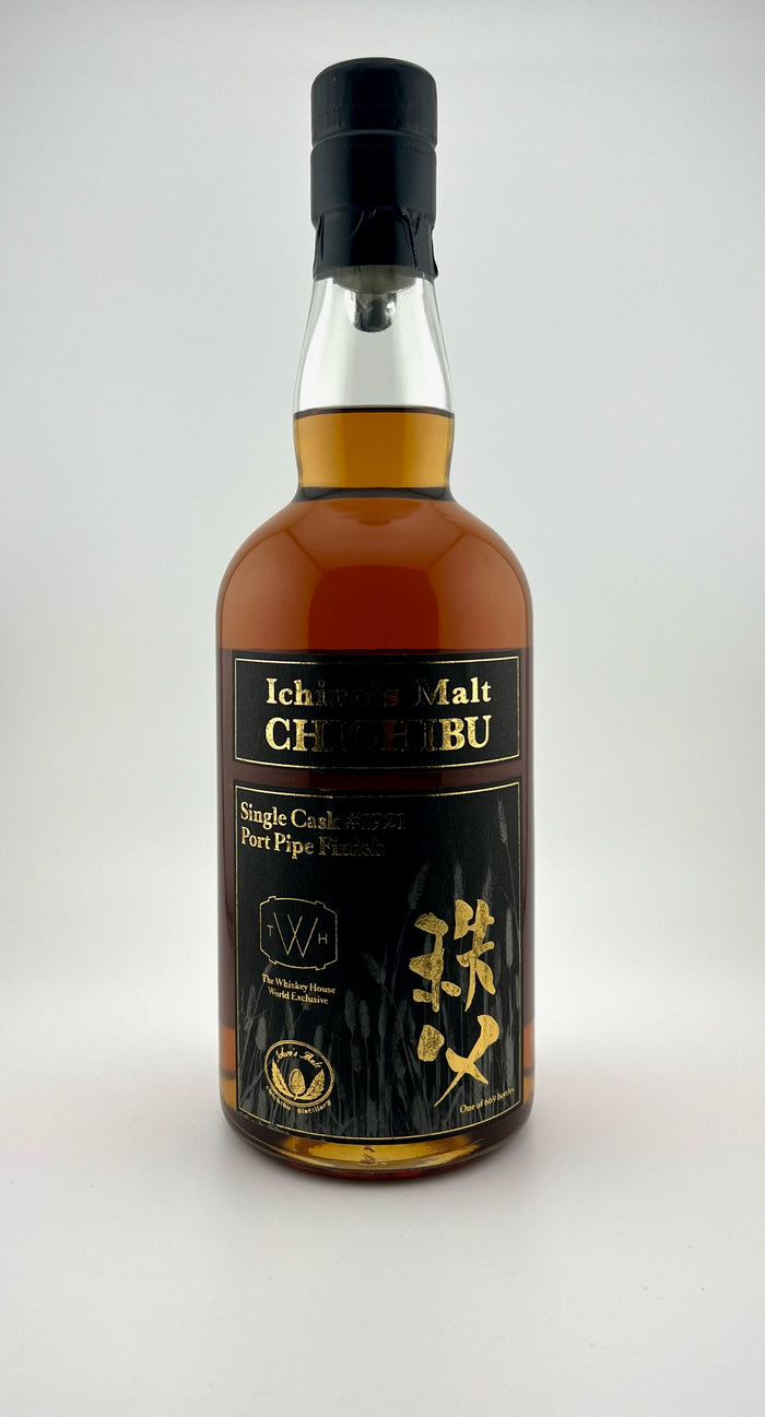 A bottle of Chichibu whisky with a label featuring Japanese text and a dark cap.